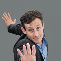David Leventhal leans toward the camera, arms separated and palms open in a strong stance