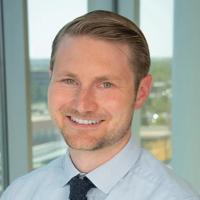 Headshot of Mark Kissler, a caucasian man with blond hair, in a blue shirt and navy tie.